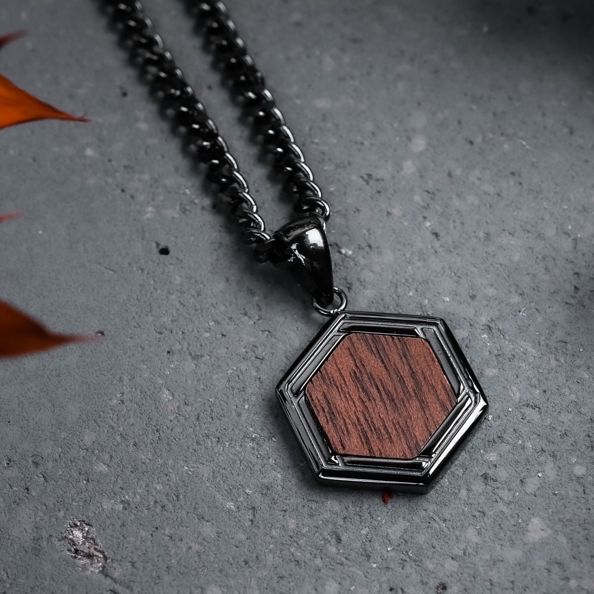 "Axis Necklace" necklace, featuring a hexagonal walnut and dark grey design.
