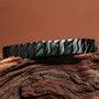 "Baritone" bracelet in sleek black with marble accents, featuring a modern, geometric design.