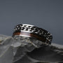 "Fractional Ring", a stylish ring crafted from walnut and silver with a sleek, modern design.