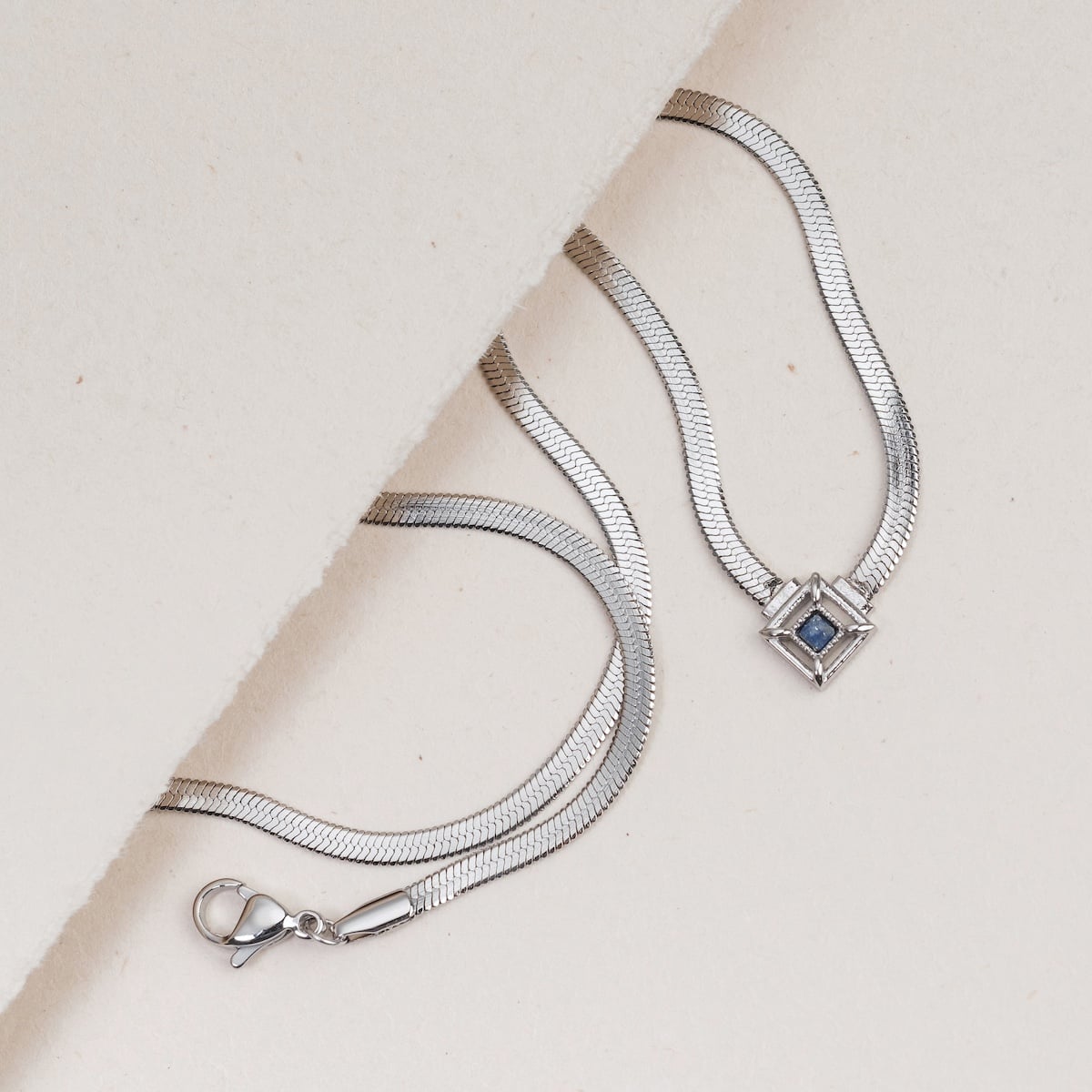 "Awakening Necklace" - Elegant silver necklace featuring a lapis lazuli center, showcasing a modern geometric design.