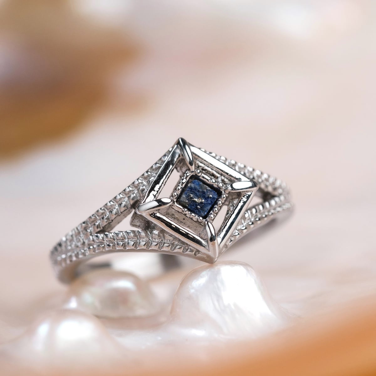 "Awakening Ring", a silver Lapis lazuli ring, features an intricate geometric design with a modern, elegant style.