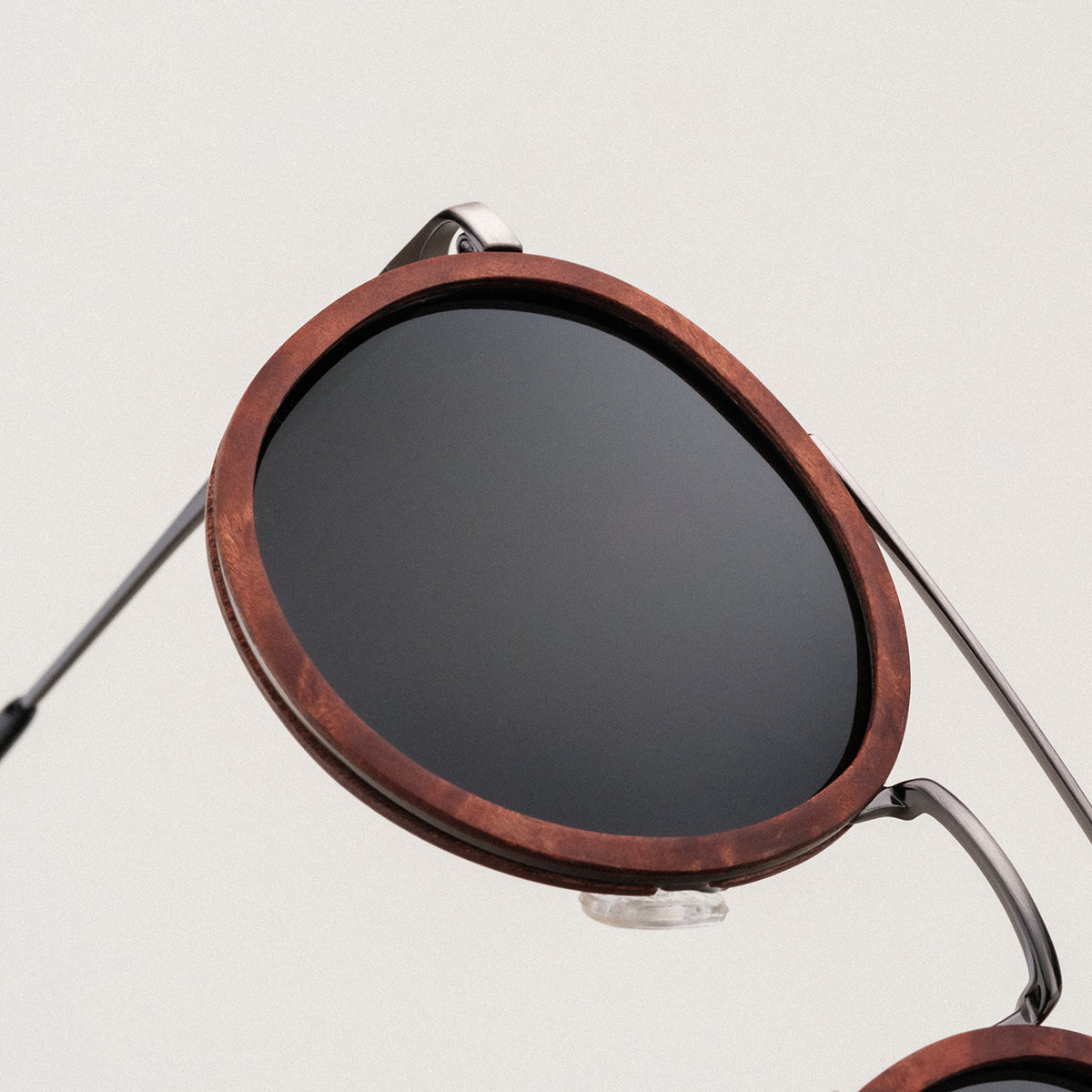 "The Enchanting" sunglasses featuring a walnut frame and antique silver accents.