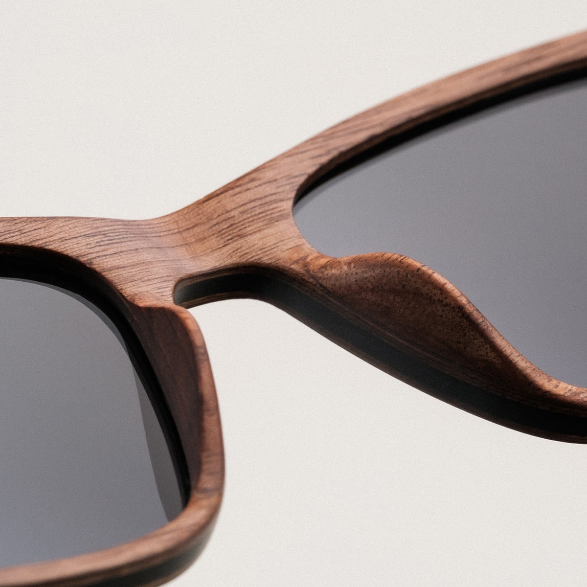 "The Extrovert" sunglasses featuring a stylish walnut frame with a modern look.