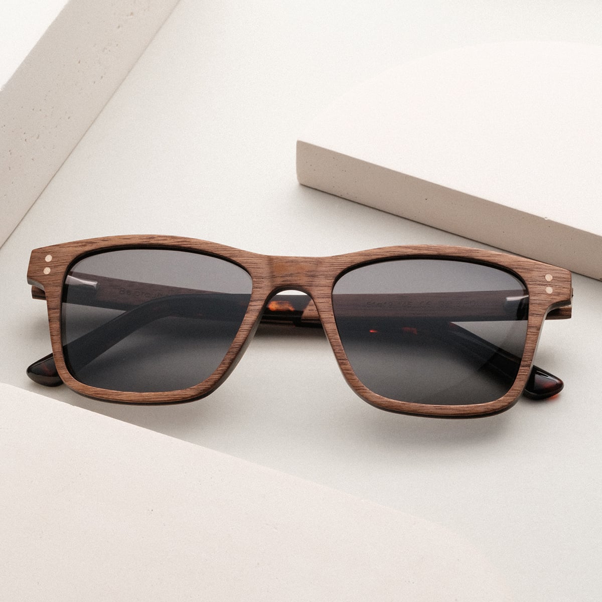 "The Extrovert" sunglasses, crafted in walnut with a sleek, modern design.