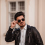 "The Honorable" sunglasses, featuring a stylish blend of teak and matte gold materials.