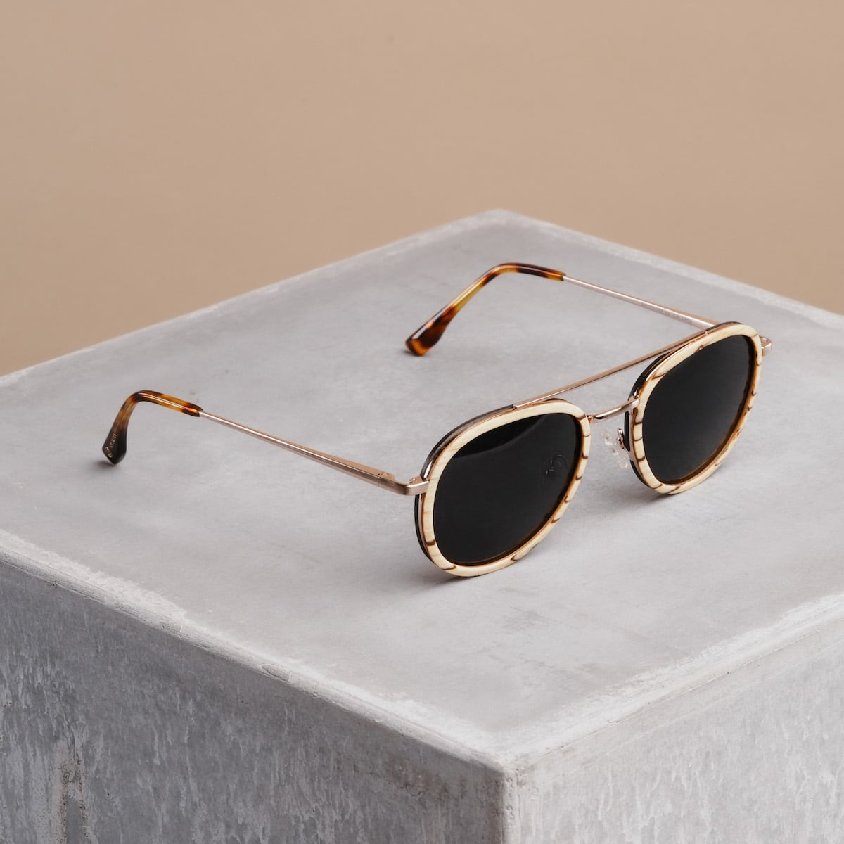 Lunettes de soleil "The Risky" avec bras zèbres et accents en or mat dans un design élégant.