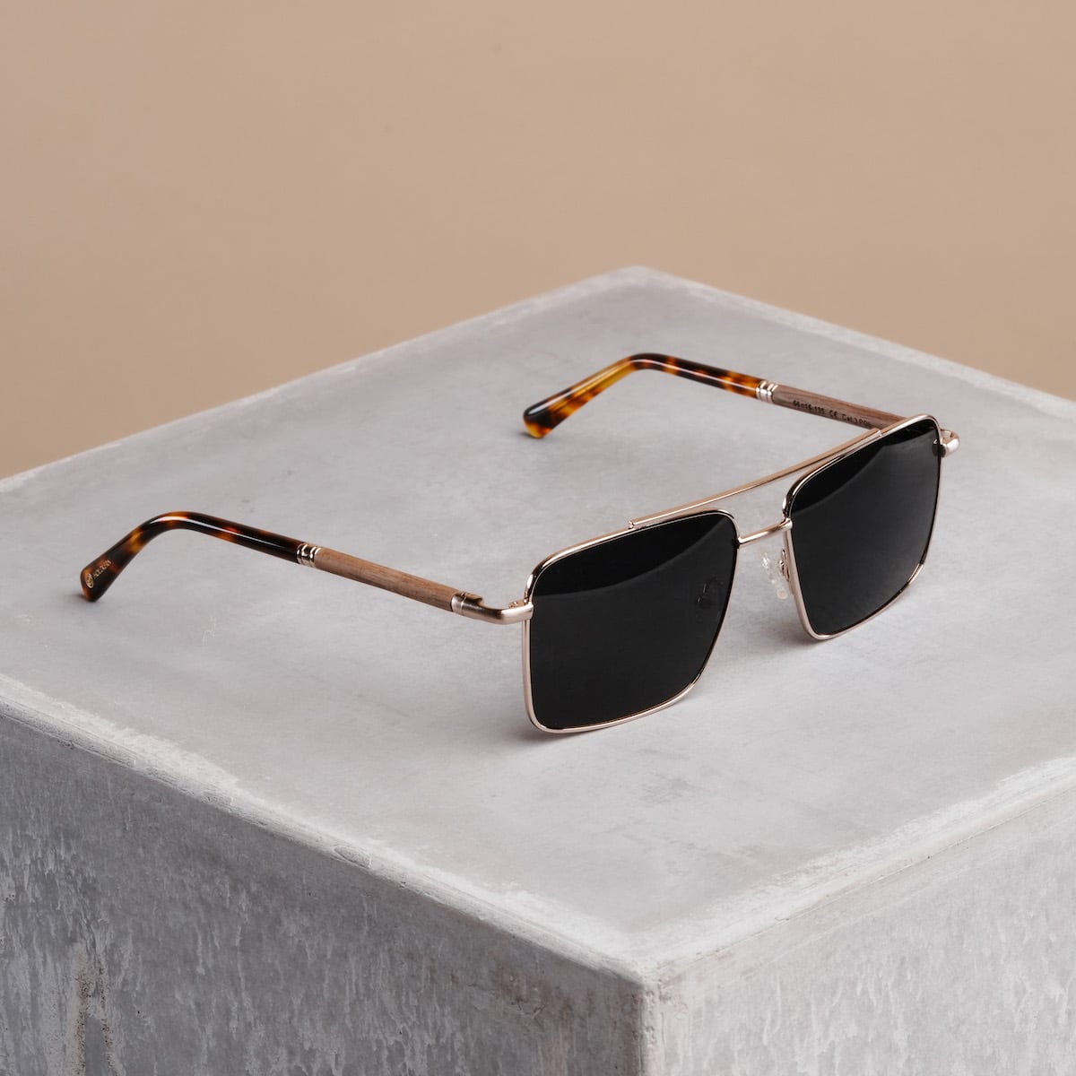 "The Talisman" sunglasses featuring a sleek walnut and matte gold design.