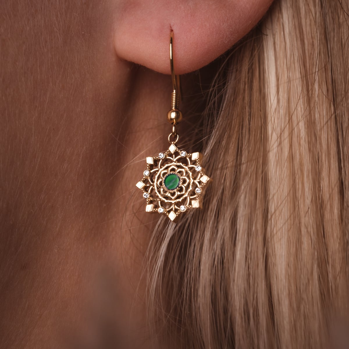 "Aphonia Earrings": Elegant jade and gold earrings with intricate design.
