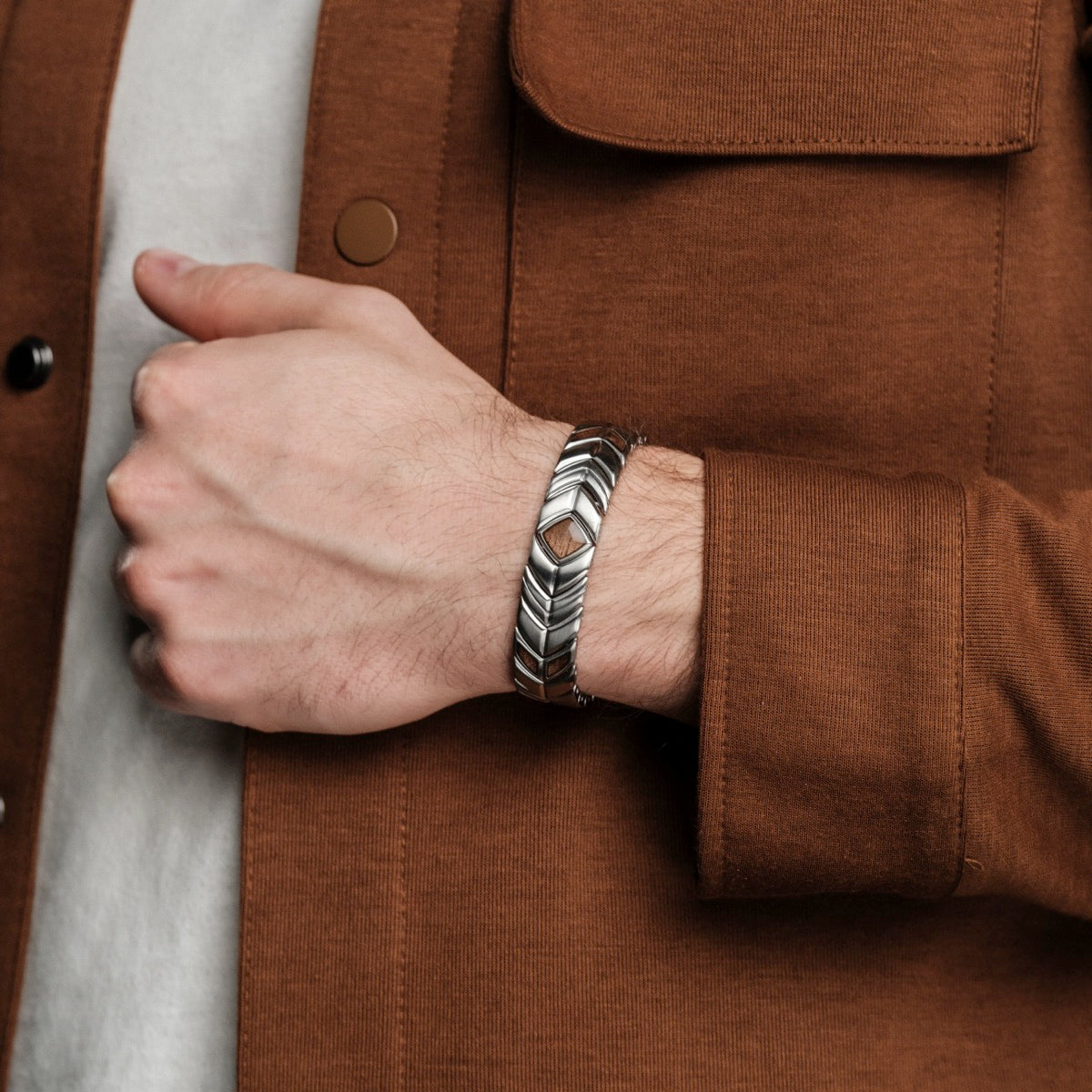 "Prelude" bracelet in a sleek walnut and silver design, worn on wrist for a stylish look.