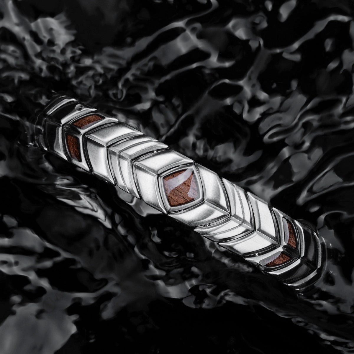 "Prelude" bracelet featuring walnut and silver, elegantly styled against a reflective black background.