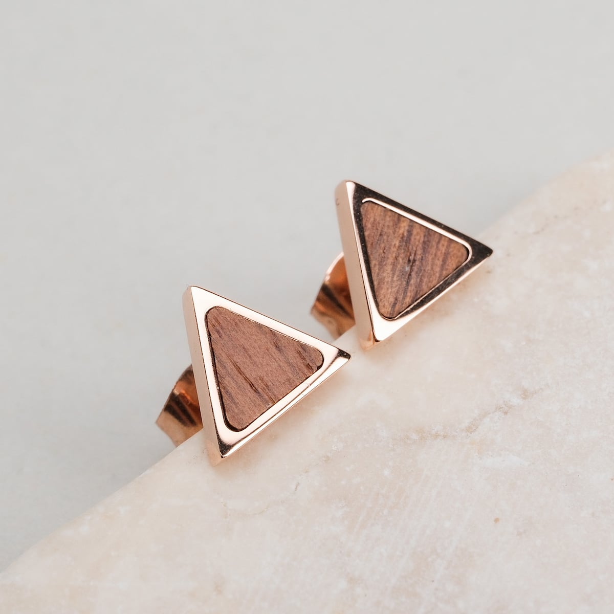 Scale Earrings: Walnut and rose gold earrings with a sleek triangular design.