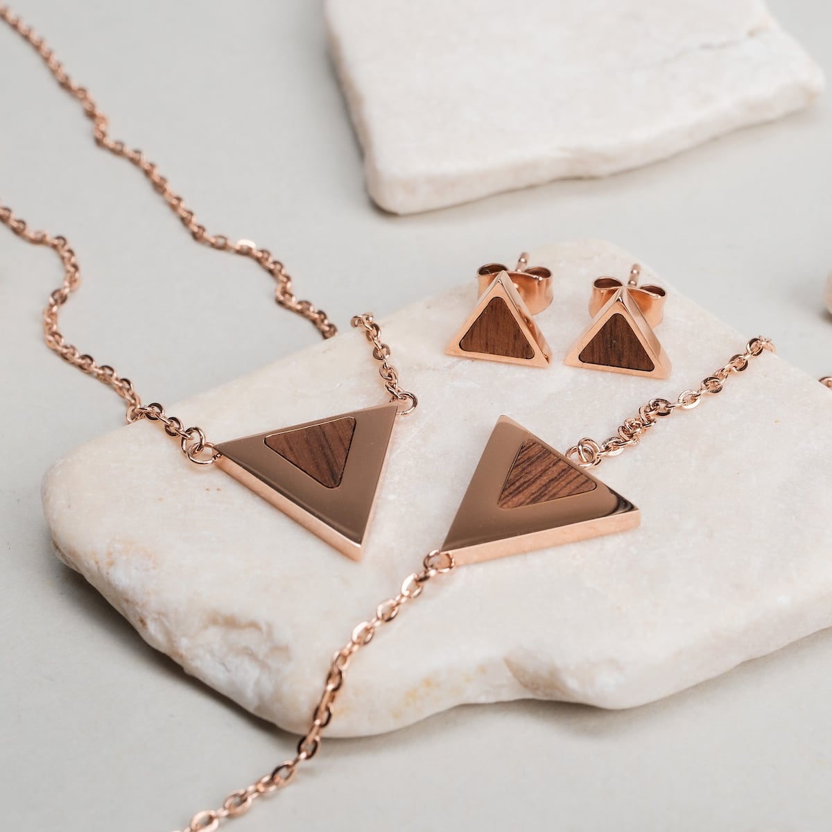 Scale Earrings: Elegant walnut and rose gold triangle earrings with a modern design.