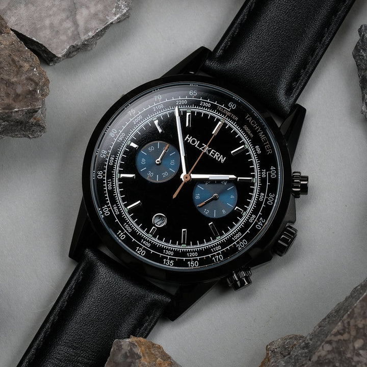"Rackets watch, featuring a black dial and leather band, showcasing a sleek and sophisticated design."