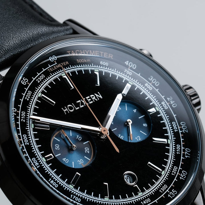 "Rackets watch with a sleek black design, featuring detailed dials and a tachymeter scale."