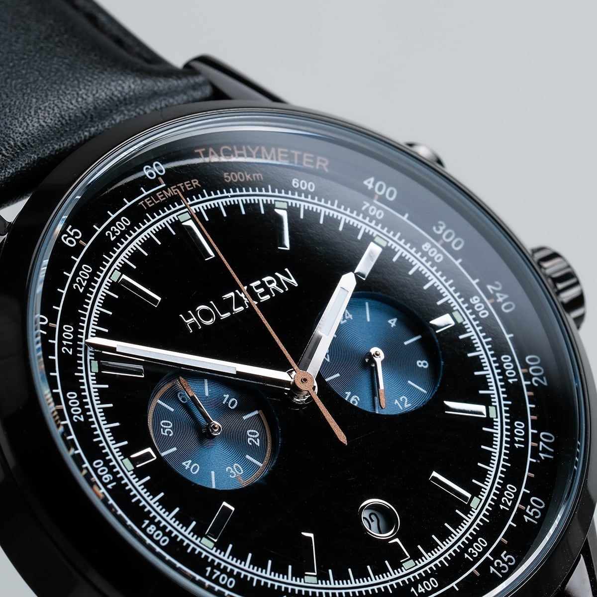 "Rackets watch with a sleek black design, featuring detailed dials and a tachymeter scale."