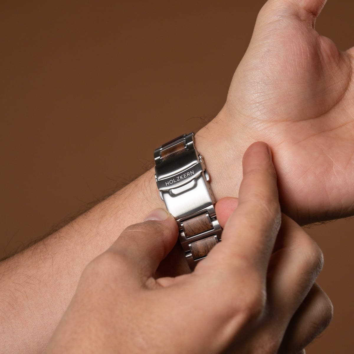 "Milestones wristwatch featuring a walnut and blue design with a sleek metallic band."