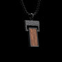 "Transcendent" pendant necklace, featuring a koa wood and antique silver design with a modern, rectangular style.