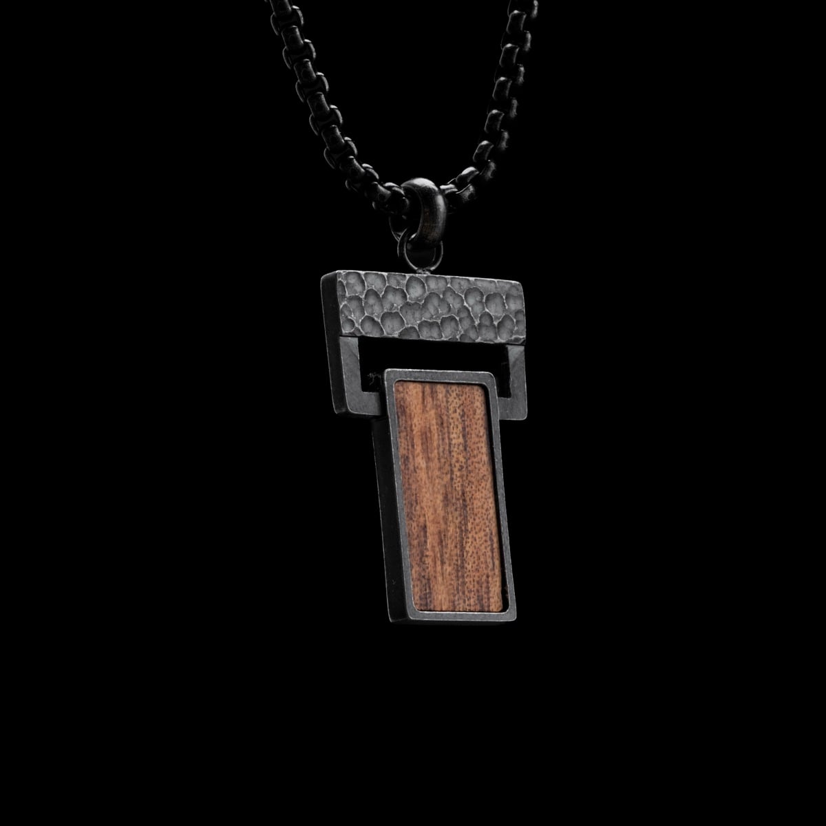 "Transcendent" pendant necklace, featuring a koa wood and antique silver design with a modern, rectangular style.