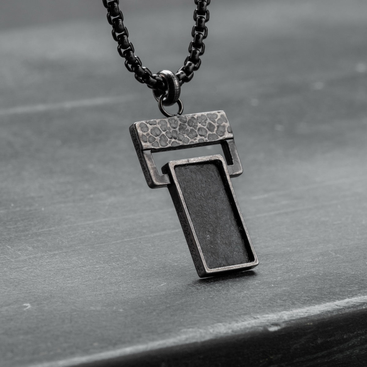 "Transcendent" pendant in slate and antique silver, featuring a modern geometric design.