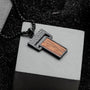 "Transcendent" pendant featuring koa wood and antique silver finish with a textured, modern design.