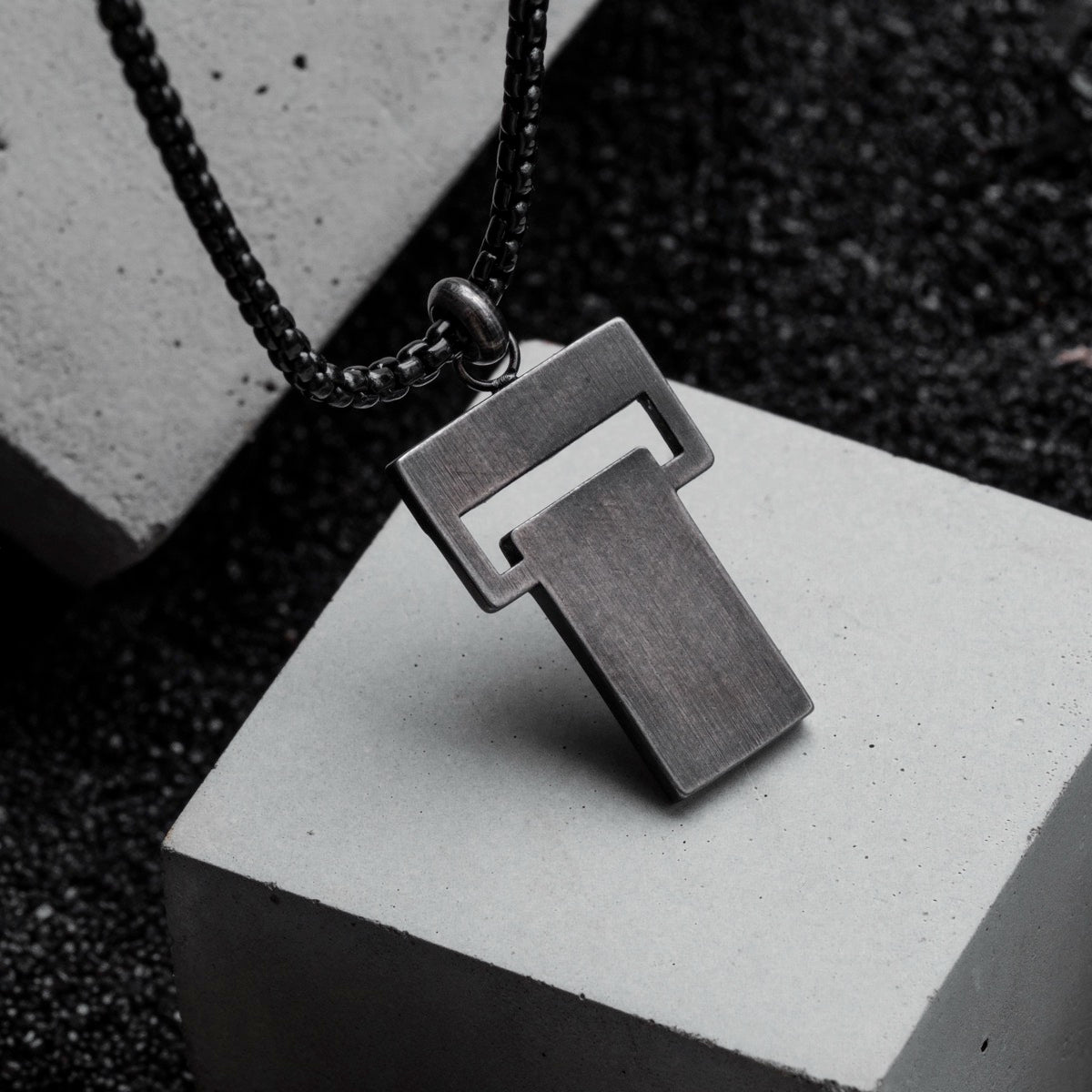 "Transcendent" necklace featuring a sleek, modern design in slate and antique silver tones.