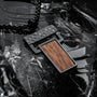 "Transcendent" pendant featuring koa wood and antique silver details in a modern, textured style.