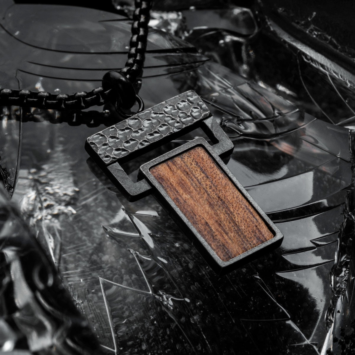 "Transcendent" pendant featuring koa wood and antique silver details in a modern, textured style.