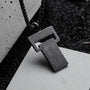 "Transcendent" artisan necklace, crafted in koa and antique silver, featuring a modern geometric design.