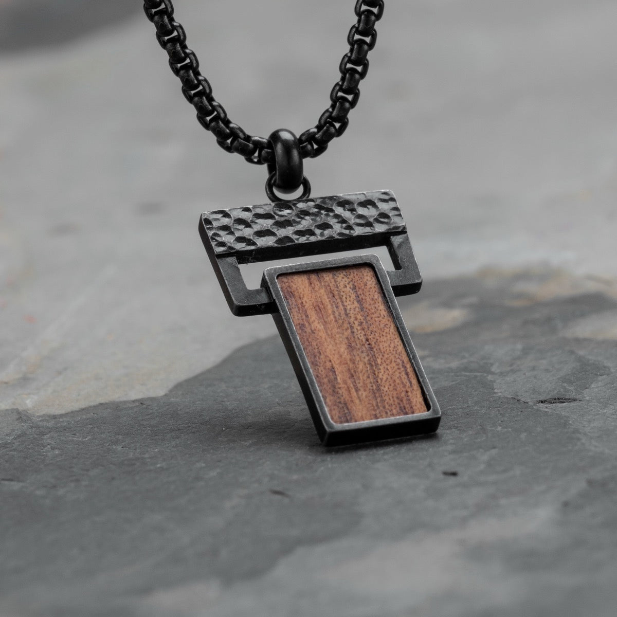 "Transcendent", a stylish pendant with koa wood and antique silver finish, featuring a modern design on a dark chain.
