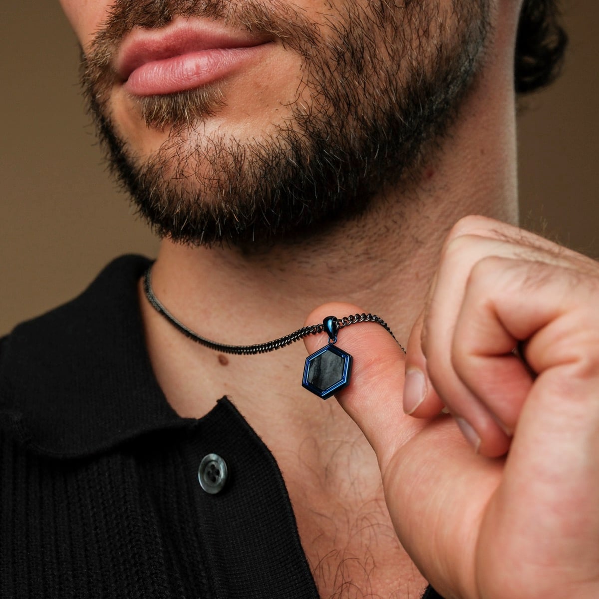 "Axis Necklace" necklace featuring a hexagonal pendant with a modern Picasso Jaspis design, showcased on a dark chain.