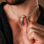 "Campania Necklace" necklace featuring a sleek sodalite and Damascus design, worn on a silver chain for a modern, stylish look.