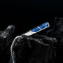 "Campania Necklace" necklace featuring a sleek Sodalite and Damascus design against a dark background.
