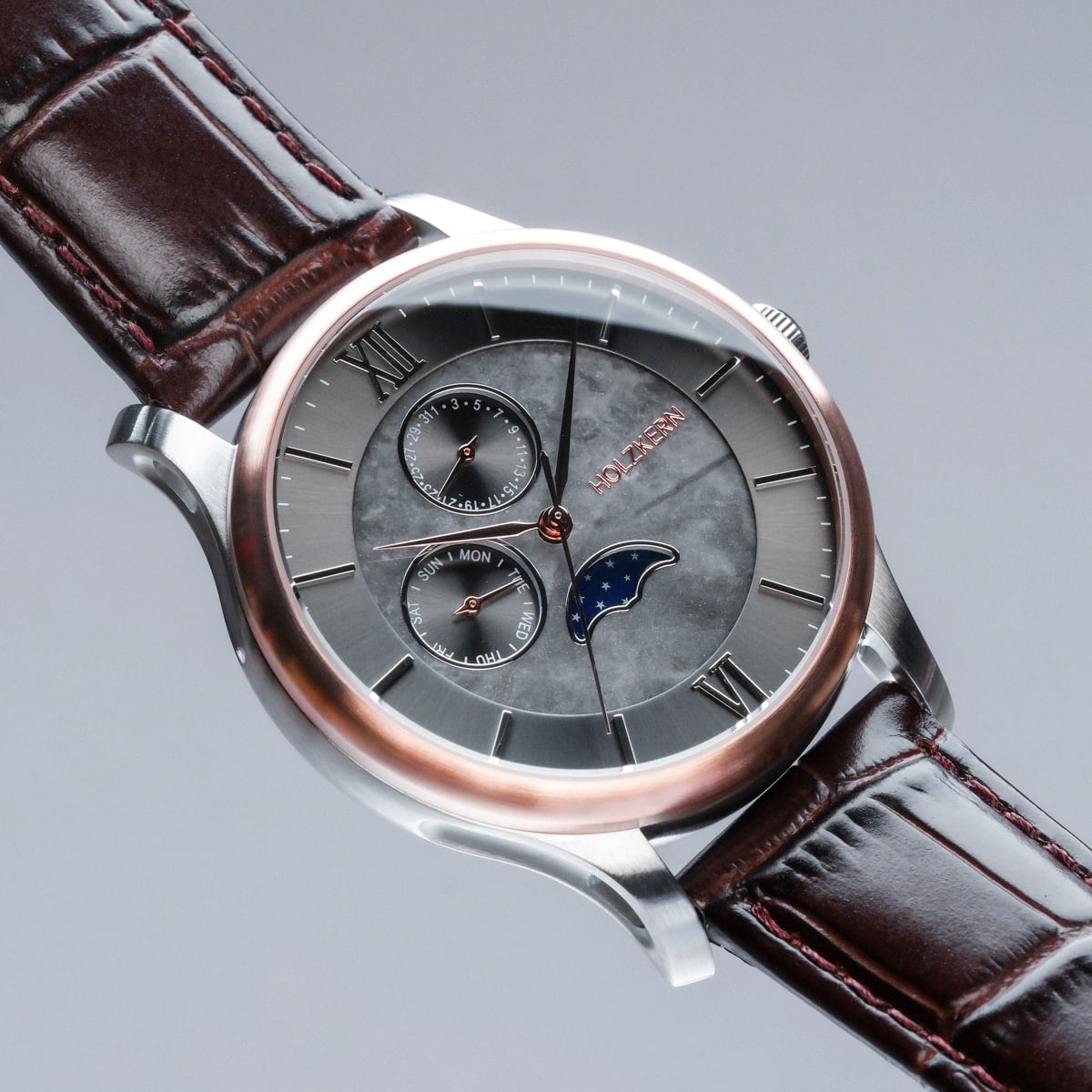 "Moonrise" wristwatch, featuring a marble dial and dark brown leather strap, with an elegant modern design.