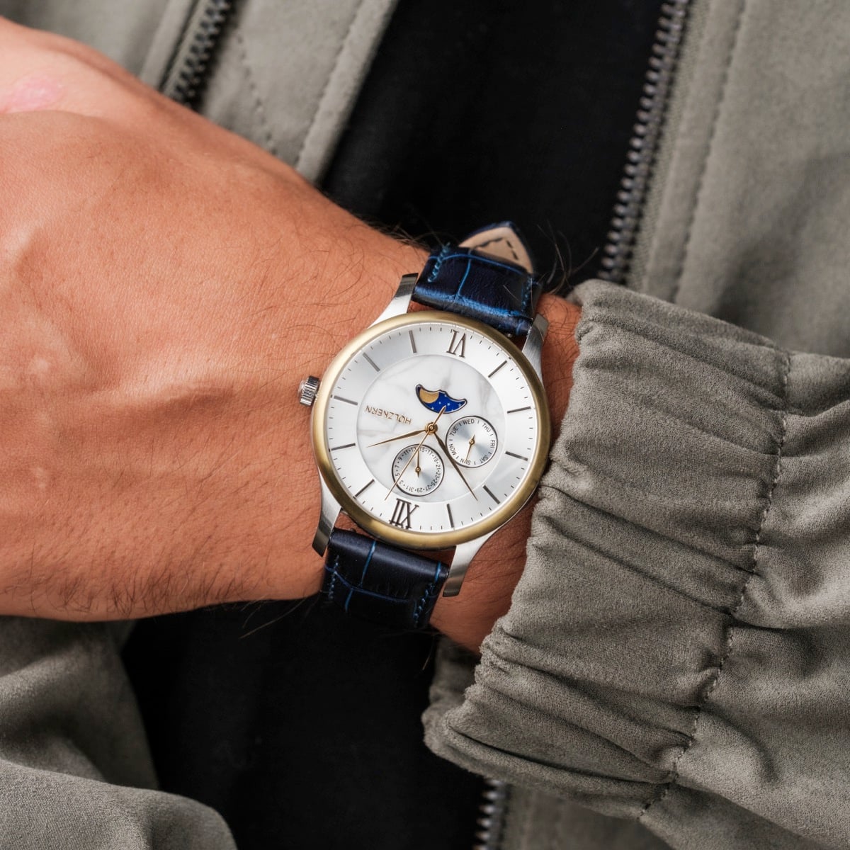"Moonrise" wristwatch featuring a marble dial and dark blue leather strap, showcasing elegant and timeless design.