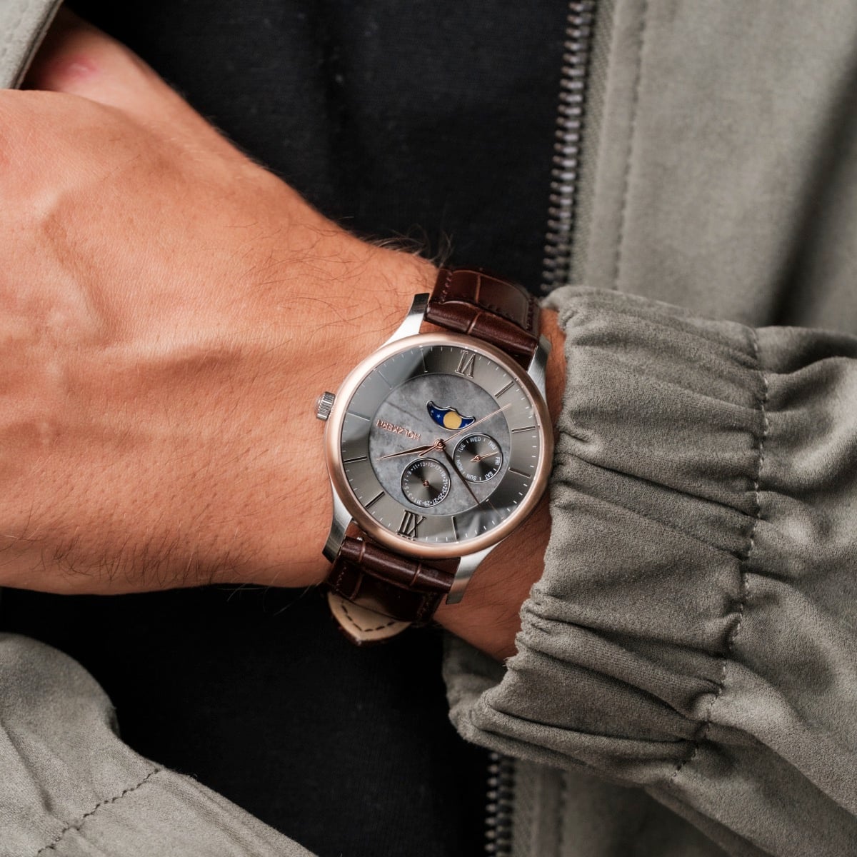 "Moonrise" wristwatch with a marble face and dark brown strap, showcasing an elegant and sophisticated style.