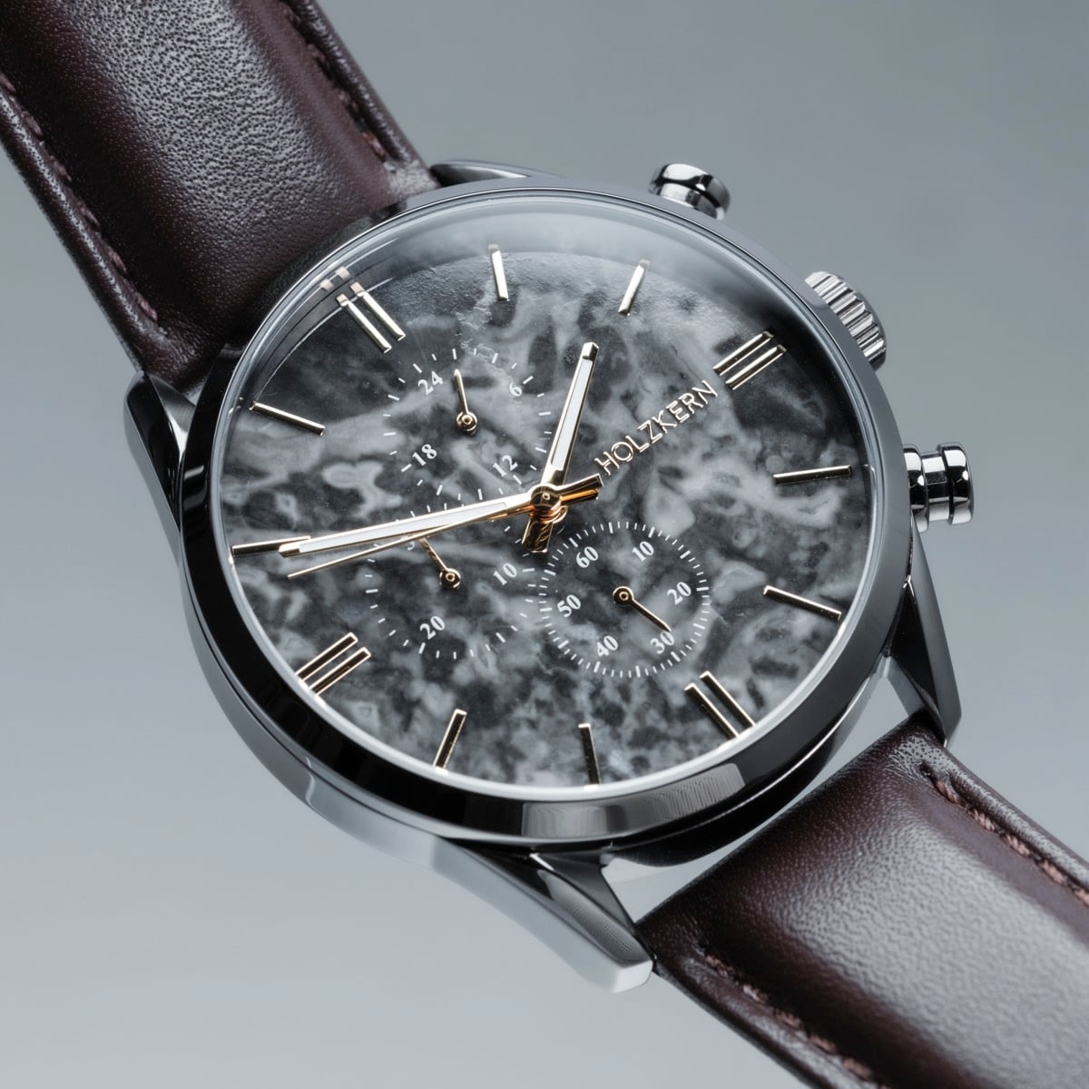 "Gifted" watch with a gray marble dial and dark brown leather strap, showcasing a modern and elegant design.
