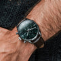 "Gifted" watch featuring a green marble face and dark brown leather strap, blending elegance and sophistication.