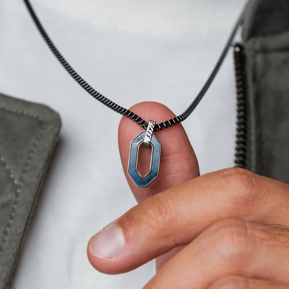"Interplay Necklace" necklace features a modern geometric design in sodalite and Damascus materials.