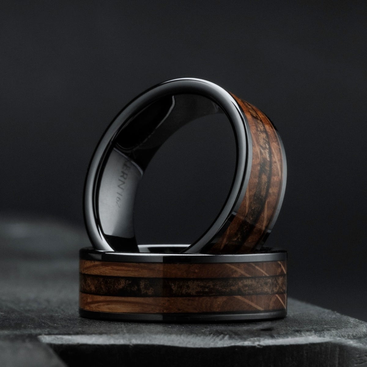 "Sumo Ring" ceramic ring featuring a whiskey wood finish, showcasing a sleek and elegant design.