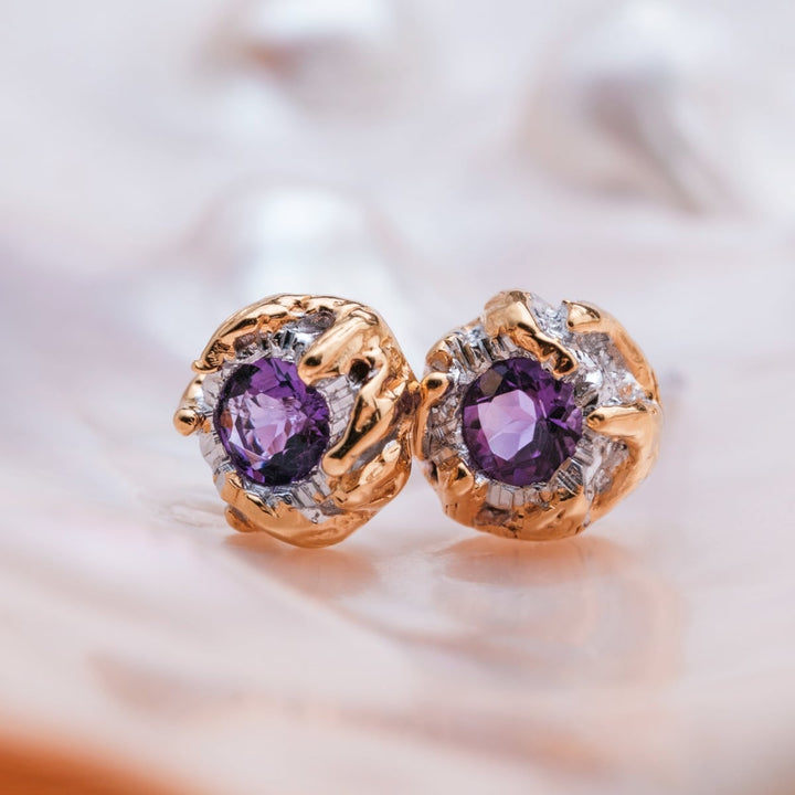 "Silverstream Earrings": Amethyst and gold earrings with a unique, elegant design.