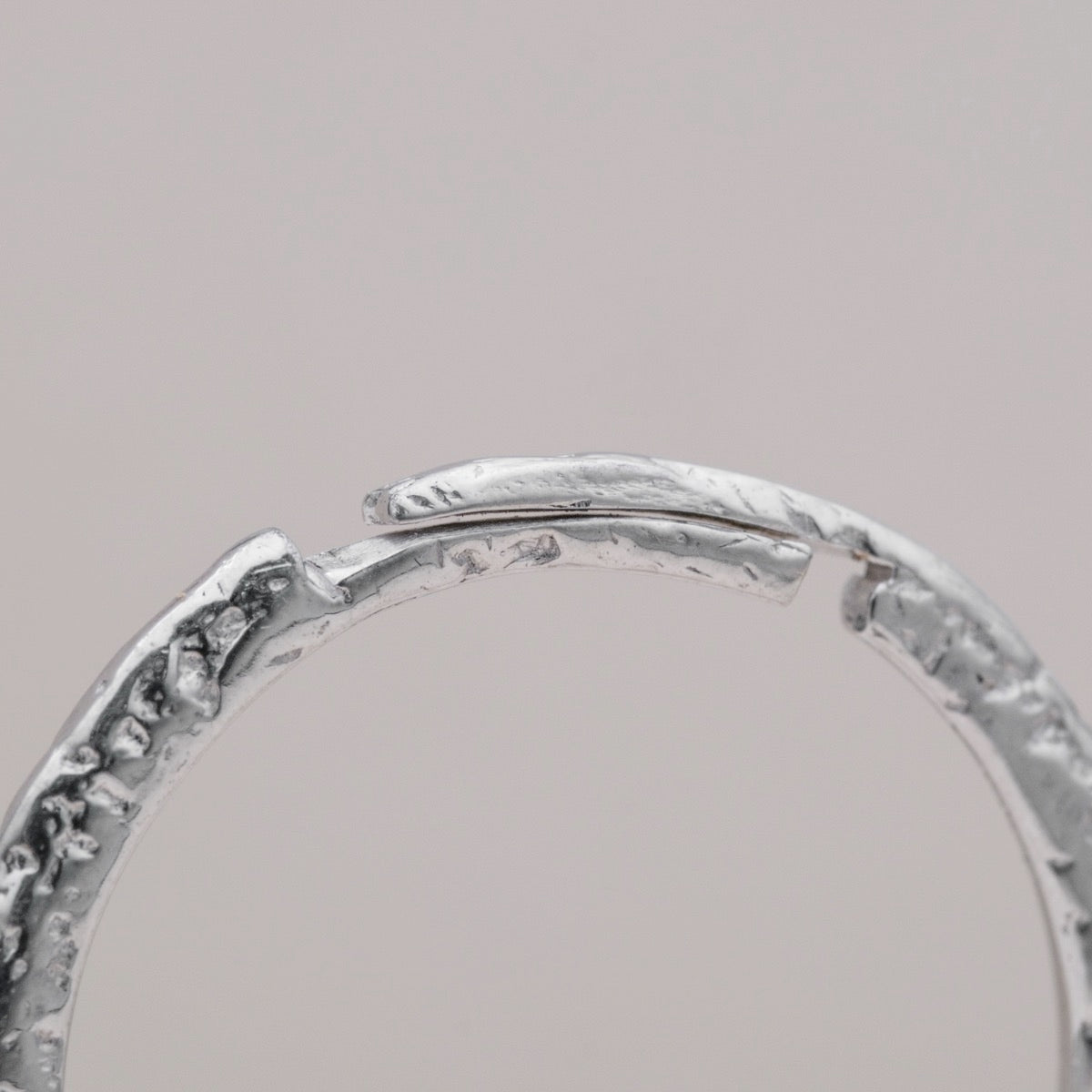 "Silverstream Ring ring, featuring a textured silver design with a modern, elegant style."