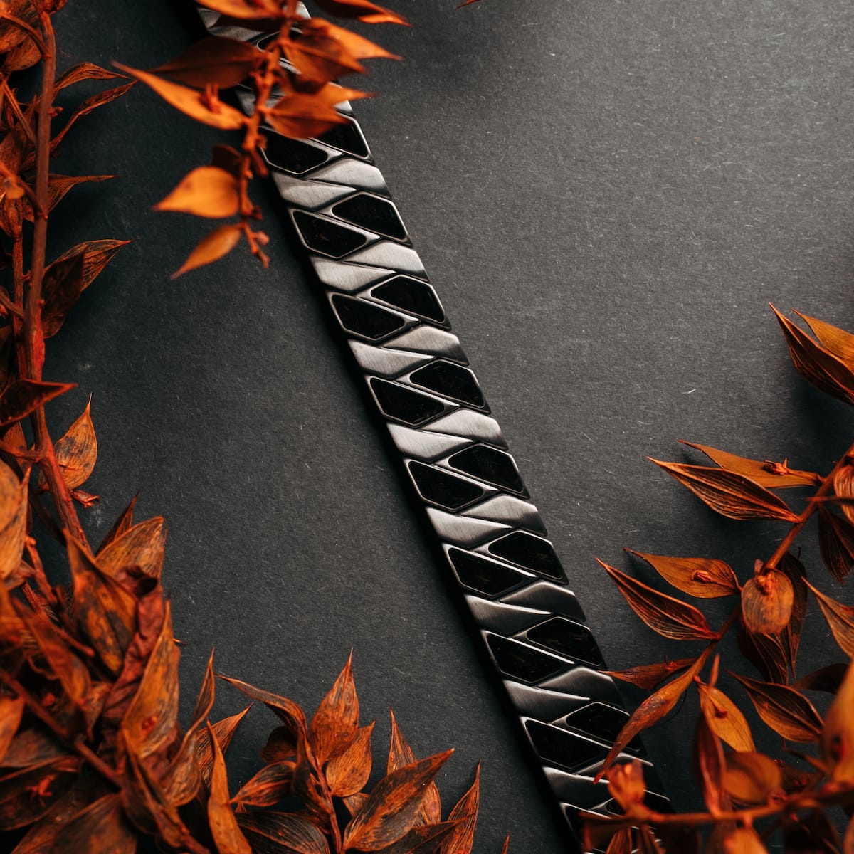 "Baritone", a dark grey accessory with maple elements, featuring an elegant geometric design.