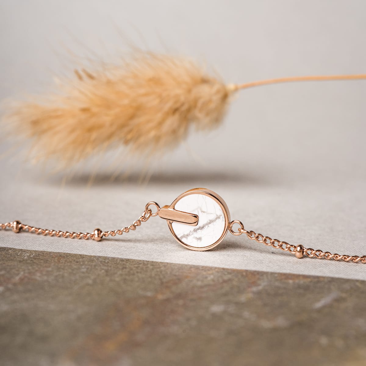 "Opacity Bracelet", a stylish bracelet featuring white marble and rose gold design.