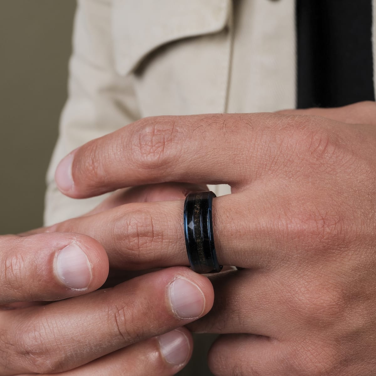 "Cartesian Ring" ring featuring a dark maple and blue design worn on a hand.