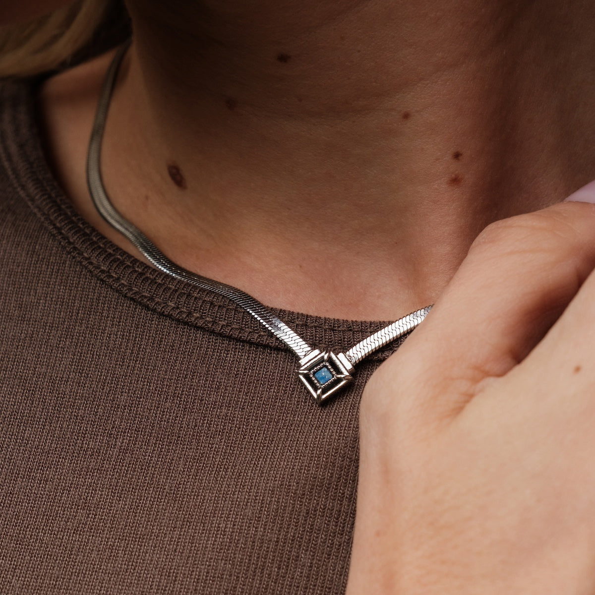 "Awakening Necklace" necklace, featuring lapis lazuli and silver, with a sleek and modern design.