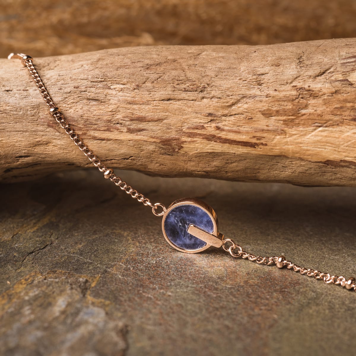 "Opacity Bracelet" bracelet featuring blue marble and rose gold, showcasing a sleek and elegant design.