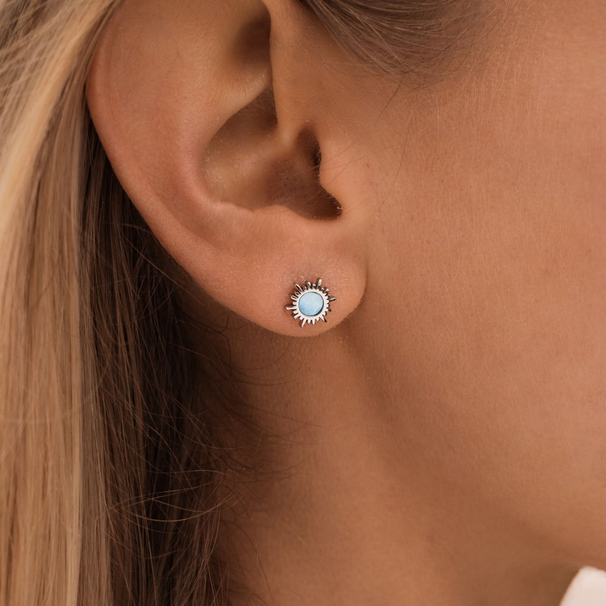 "Shade Earrings": Elegant silver earrings featuring blue nacre with a stylish sunburst design.