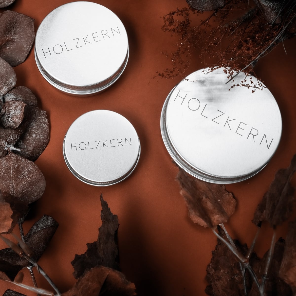 "Wood Care Balm 60ml" is a beautifully packaged balm in a sleek, round tin, presented on a rustic background.