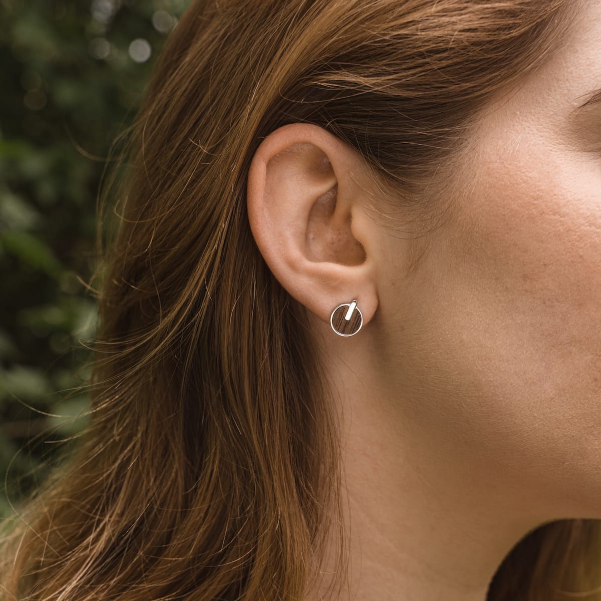 Opacity Earrings: Elegant walnut and silver earrings with a modern circular design.