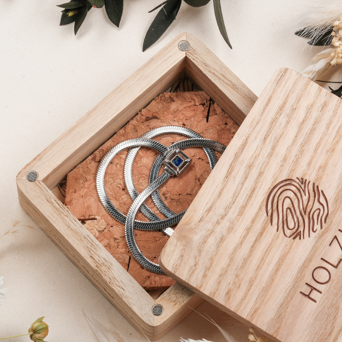 "Awakening Necklace", a stylish silver necklace with lapis lazuli, presented in an elegant wooden box.